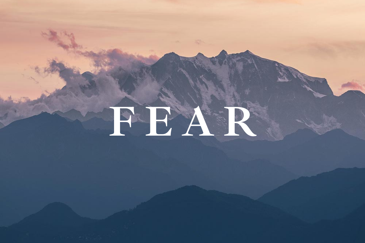Mountains at sunrise with the word "fear" in the middle